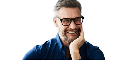 A man holding his jaw, wincing in pain from a toothache.