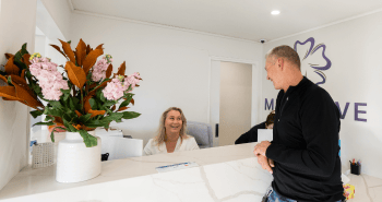 Mulgrave Dental Group patient interacting with staff at the front desk.