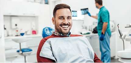 Smiling man in a dentist office.