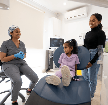 Dr. Diluni and a young Mulgrave Dental Group patient in a consultation with her parent.