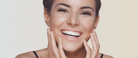 Close up of a smiling woman with a radiant, bright smile.