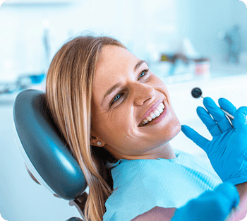 Smiling woman in a dentist chair.