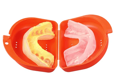 Dental mouthguard placed inside a storage case.