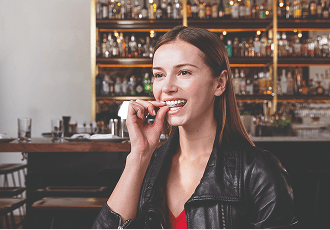 Woman removing her Invisalign at a restaurant.