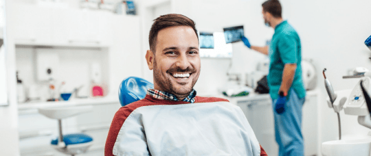 Smiling man in a dentist office.