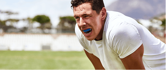 A man playing sports with a dental mouthguard.
