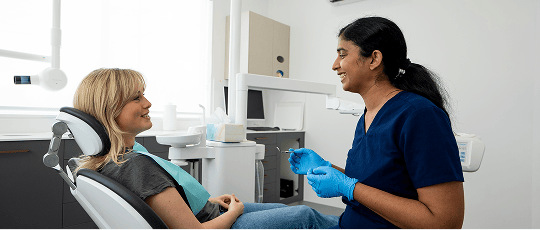 Dr. Diluni in a dental consultation with a Mulgrave Dental Group patient.