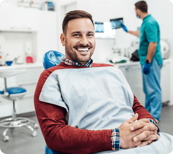 Smiling man in a dentist office.