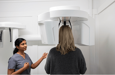 Mulgrave Dental Group Principal Dentist Dr. Diluni with a patient at the CBCT X-ray machine.