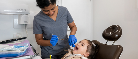 Image of a Mulgrave Dental Group dentist performing a dental check-up on a young child, providing paediatric dental care.
