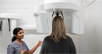 Mulgrave Dental Group Principal Dentist Dr. Diluni with a patient at the CBCT X-ray machine.