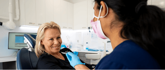 Dr. Diluni showing a Mulgrave Dental Group patient a clear aligner.
