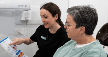Mulgrave Dental Group Oral Health Therapist educating a patient on how best to maintain their oral health.