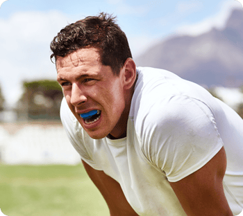 A man playing sports with a dental mouthguard.
