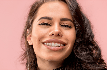 Smiling woman with a set of clear braces.