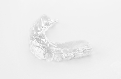 Close up of a dental splint on a white background.