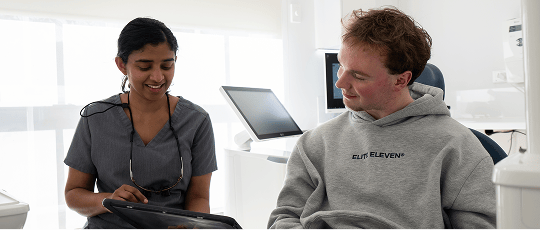 Dr. Diluni in a dental consultation with a Mulgrave Dental Group patient.