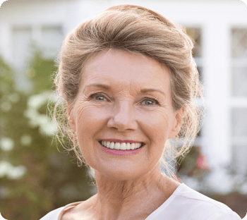 A senior woman with a beautiful denture smile.