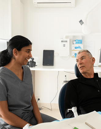 Dr. Diluni in a consultation with a Mulgrave Dental Group patient.