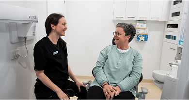 Oral Health Therapist from Mulgrave Dental Group smiling with a patient during a friendly dental consultation.