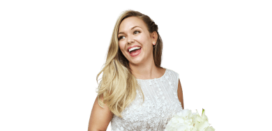 Beautiful smiling bride wearing a wedding dress, holding a bouquet, and showing off a perfect smile.