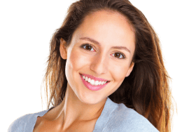 A smiling woman showing off a beautifully aligned smile.