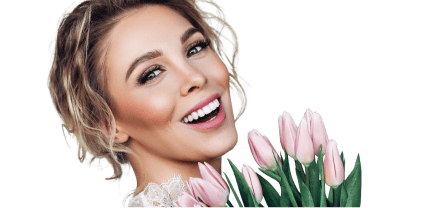 Beautiful smiling bride wearing a wedding dress, holding a bouquet, and showing off a bright smile.