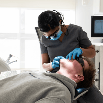 Image of Mulgrave Dental Group dentist performing a dental check-up on a patient in the clinic.