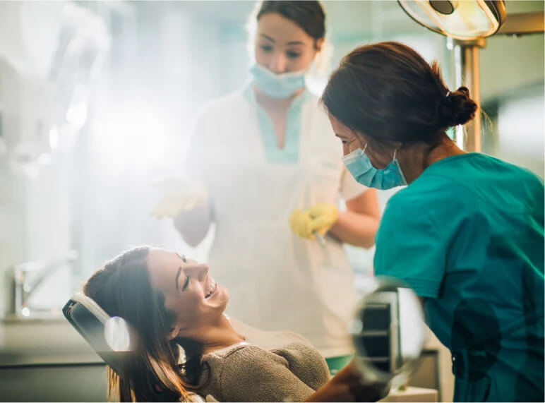  Patient in Dentist Chair getting Teeth Cleaning & Smiling while Talking to Dentist - Mulgrave Dental Group