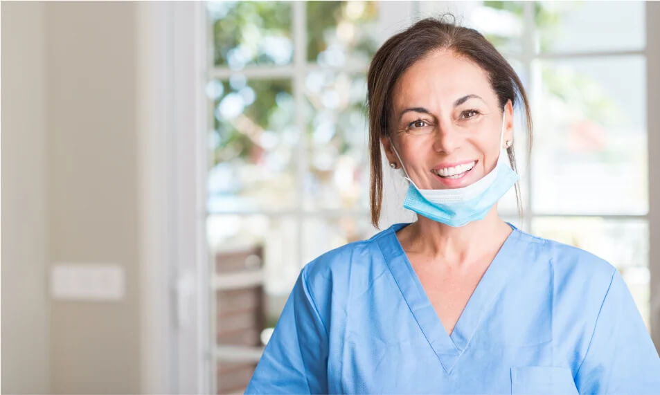  Female Dental Assistant Smiling with Mask on Face - Mulgrave Dental Group